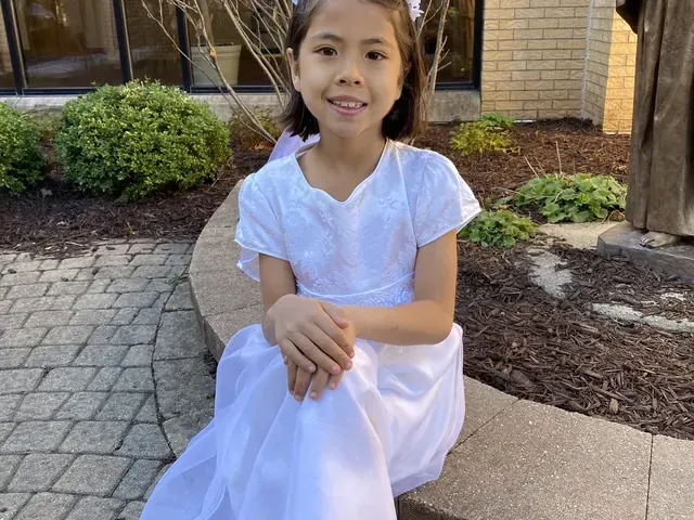 Family photo: child dressed in white outdoors