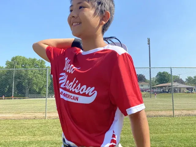 Family photo: young baseball player on the field