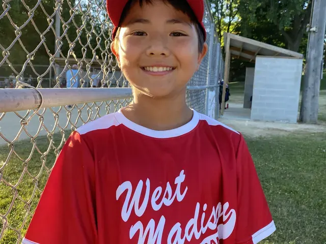 Family photo: young baseball player in a red uniform