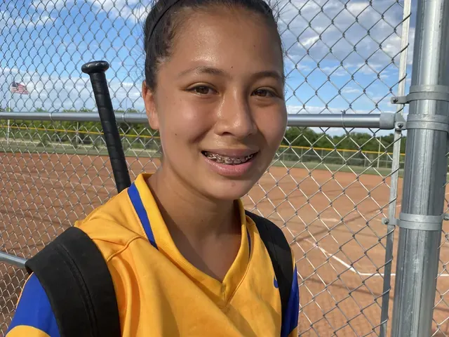 Family photo: young softball player at the ballpark
