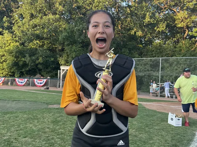 Family photo: young softball player smiling on the field
