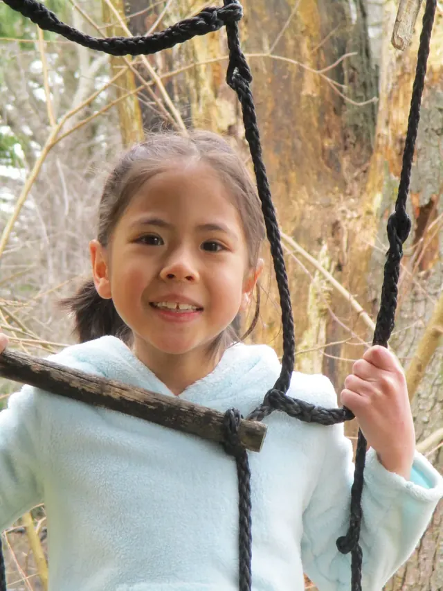 Family photo: child exploring a wooded area