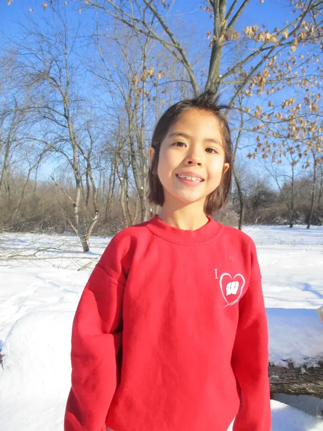 Family photo: child smiling on a snowy day