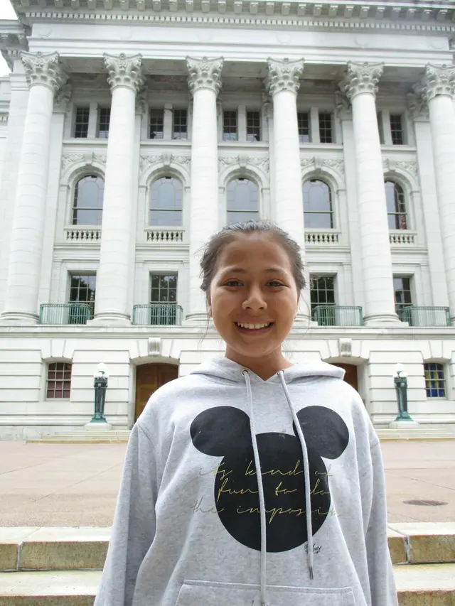 Family photo: child standing outside a civic building