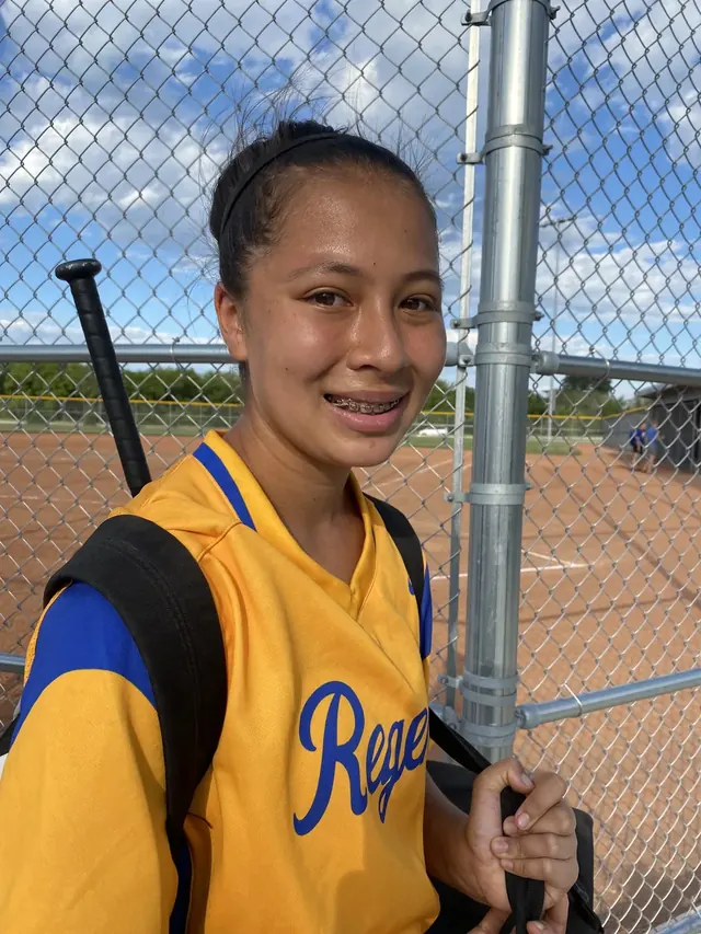 Family photo: young softball player near the field